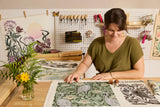 Katie Hayes working on a craft project with floral patterns in a workshop setting.