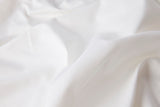 Close-up of white Cotton Sateen fabric with folds