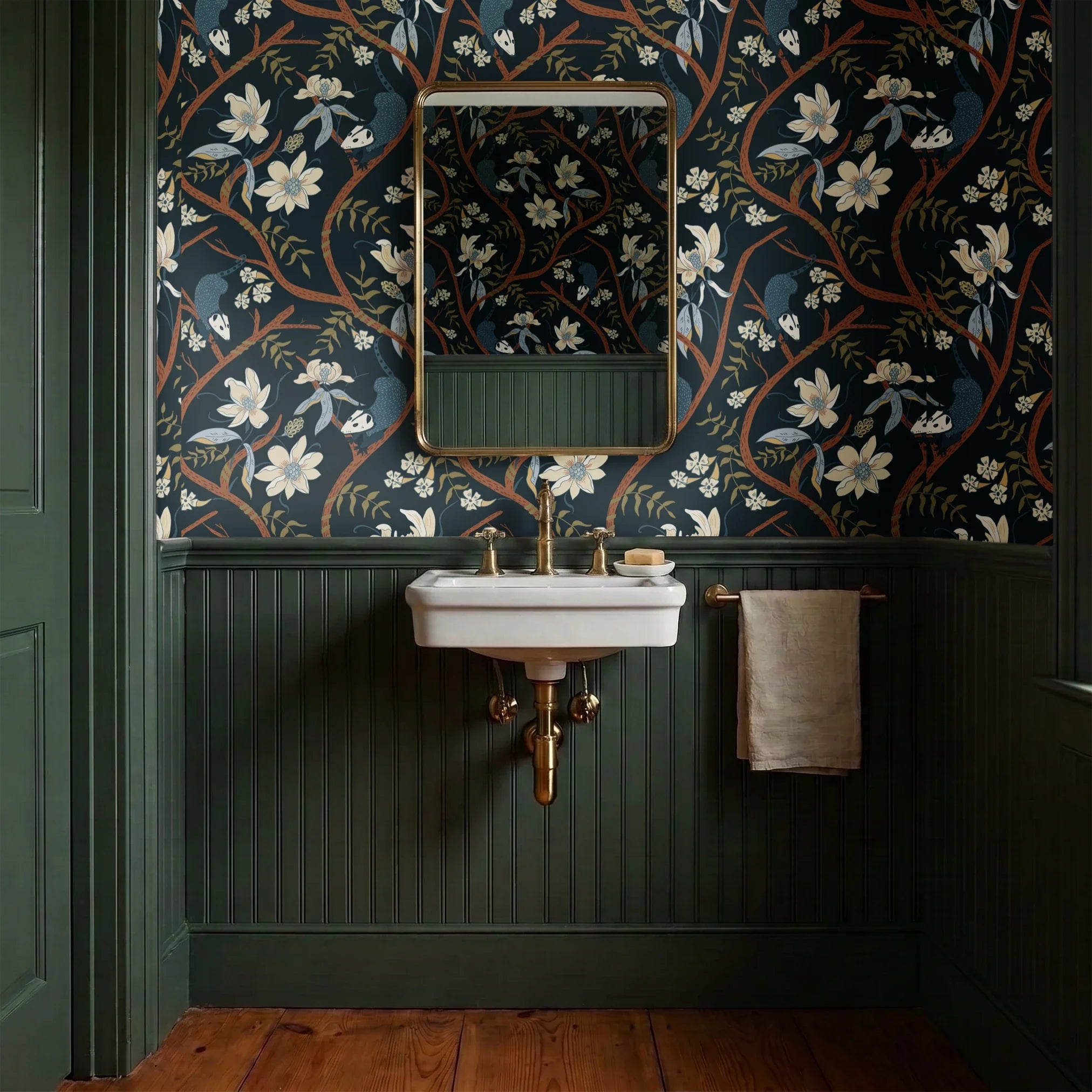 Dark floral pattern with cream magnolias, blue berries, green leaves and brown branches on black bac