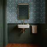 Symmetrical art nouveau pattern with stylized birds, lotus flowers, and foliage in blue, coral, and