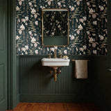 Vintage botanical pattern with cream and pink flowers on dark green background