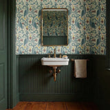 Decorative pattern with blue birds, lotus flowers, and foliage in muted teal, mauve, and cream tones