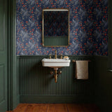 Blue wallpaper pattern with white herons, coral flowers, and green foliage in an Art Nouveau style