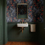Herons and cranes among reeds and red flowers on dark blue background in decorative pattern