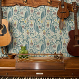 Decorative pattern with blue birds, lotus flowers, and foliage in muted teal, mauve, and cream tones