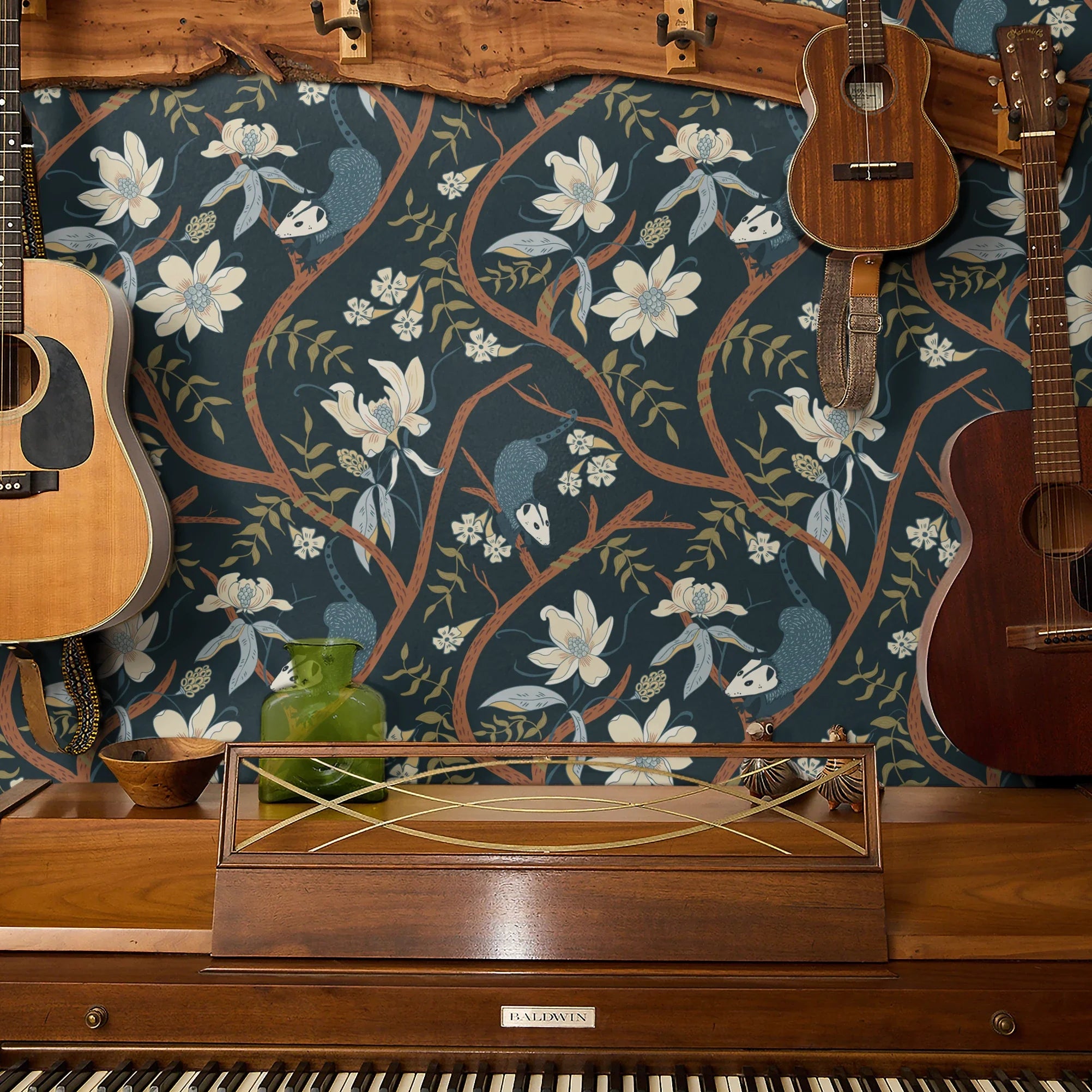 Dark floral pattern with cream magnolias, blue berries, green leaves and brown branches on black bac