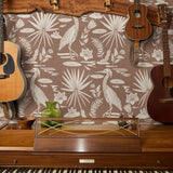 Tropical bird and palm leaf pattern in cream on terracotta brown background