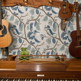 Birds and pine cones on branches in blue, green, and beige decorative pattern