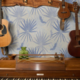 Blue and gray tropical palm fronds pattern on light textured background