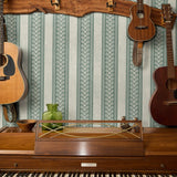 Vertical striped pattern with ornate scrollwork borders in sage green and cream tones