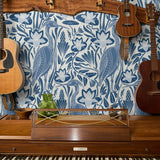 Blue and white decorative pattern with birds, flowers, and foliage in folk art style