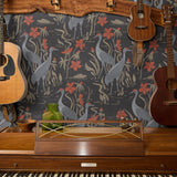 Decorative pattern with gray herons, red flowers, and beige foliage on dark background