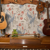 Decorative pattern with blue herons, beige cranes, and red flowers on cream background