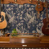 Herons and cranes among reeds and flowers in beige on dark navy blue background