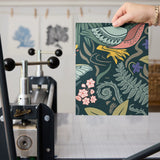Dark botanical pattern with birds, hedgehogs, flowers and foliage in muted tones