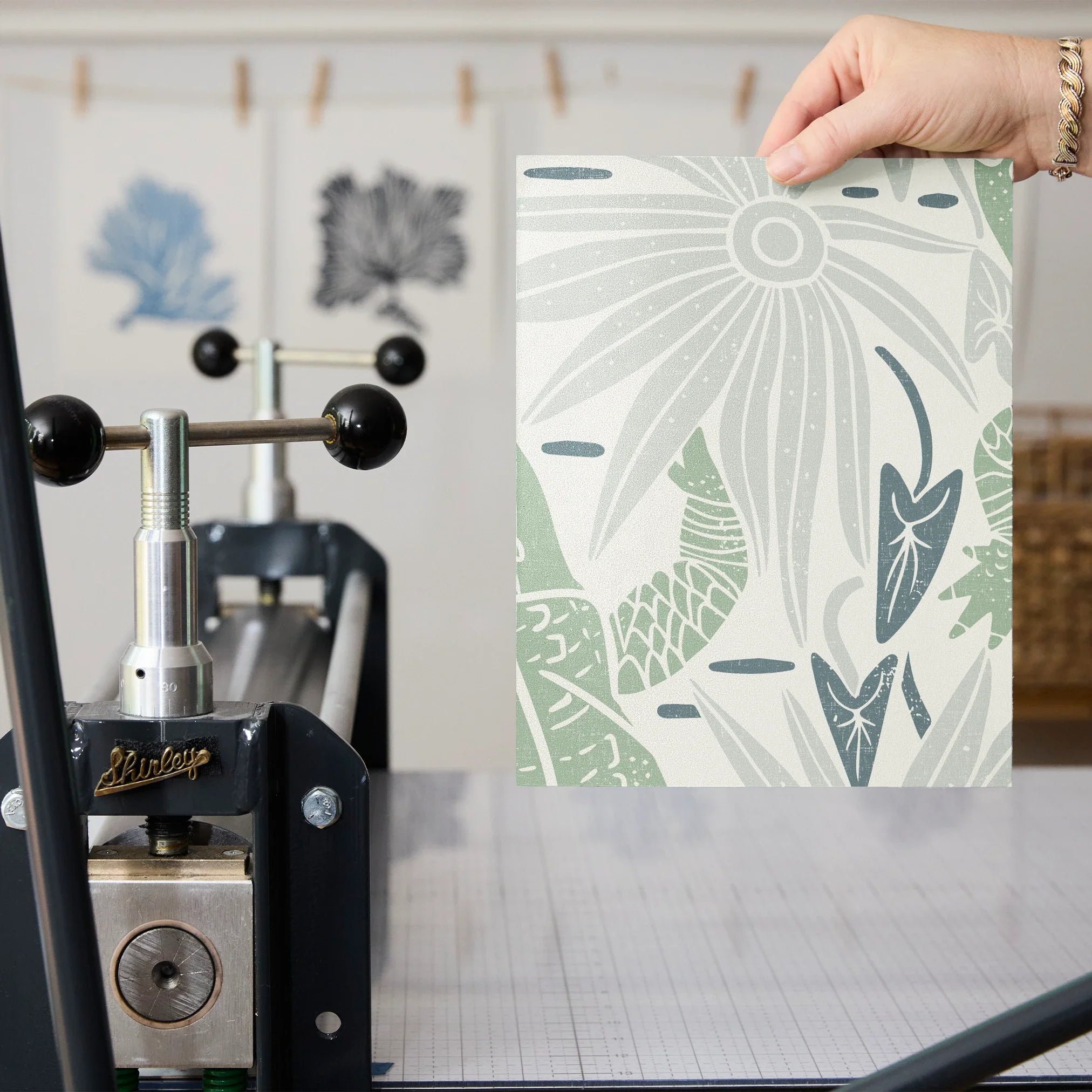 Desert botanical pattern with cacti, flowers, and abstract shapes in sage green, peach, and navy