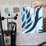 Blue and white tropical pineapple damask pattern with stylized leaves and geometric motifs