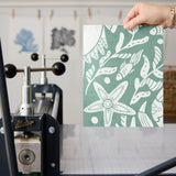Symmetrical sea-themed pattern in sage green and white featuring crabs, starfish, shells, and marine