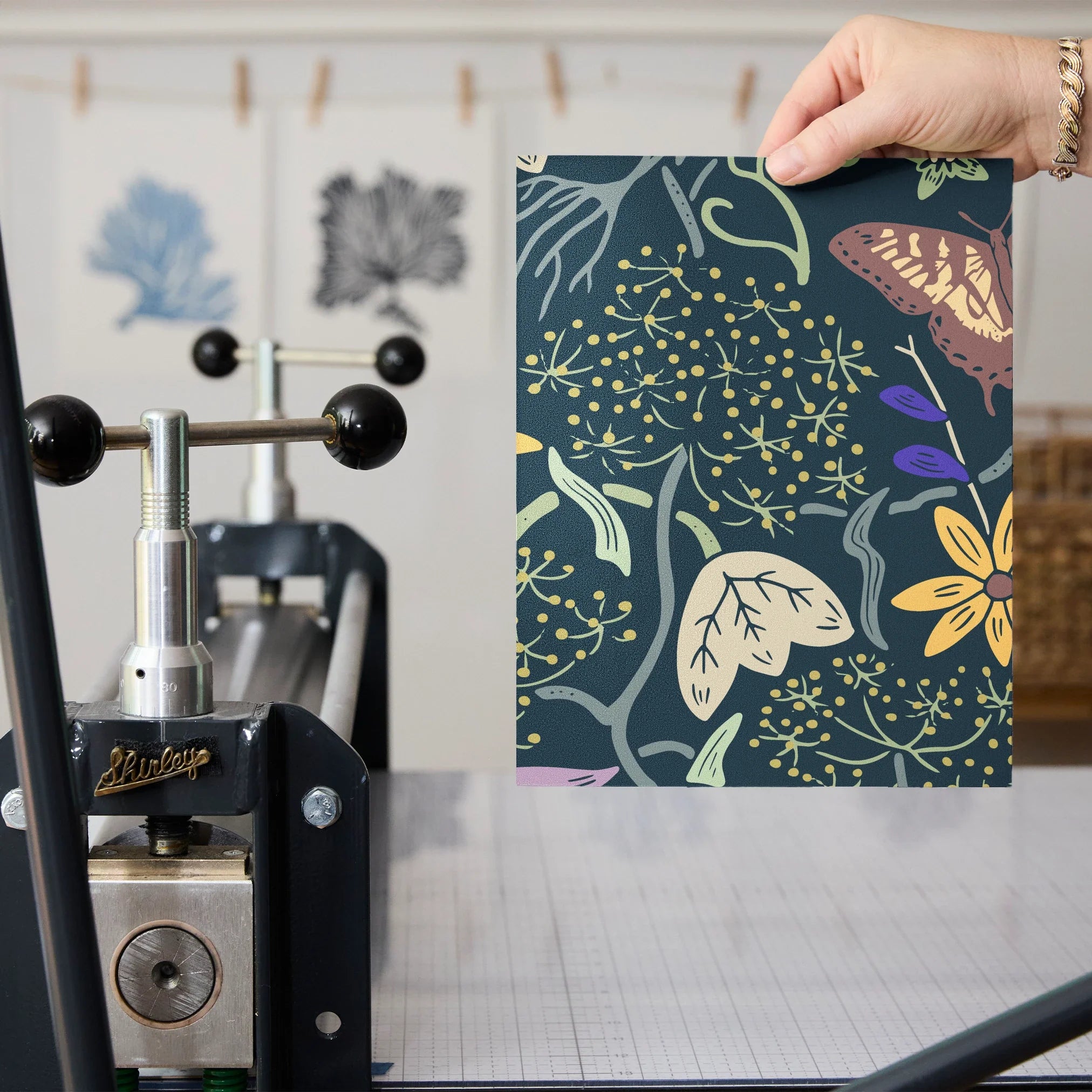 Vibrant floral pattern with colorful flowers, birds, and foliage on dark teal background