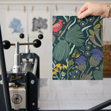 Dense floral pattern with red birds, tropical leaves, flowers and berries on dark teal background