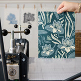 Art Nouveau style botanical pattern with blue-green tones featuring stylized flowers, leaves, and or
