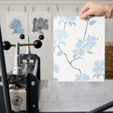 Delicate blue floral pattern with stems and leaves on white background