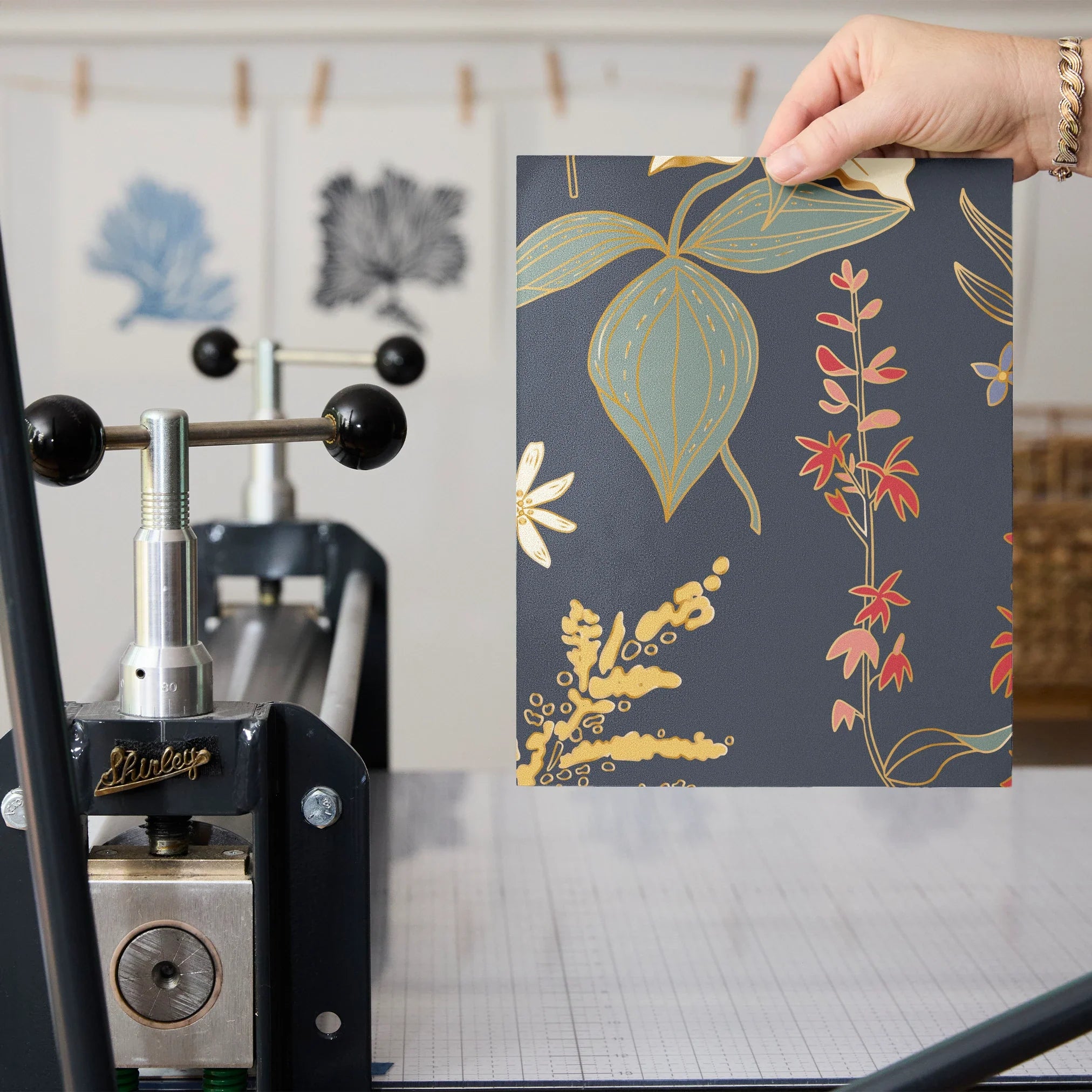 Vintage floral pattern with white flowers, golden stalks, and red blooms on dark gray background