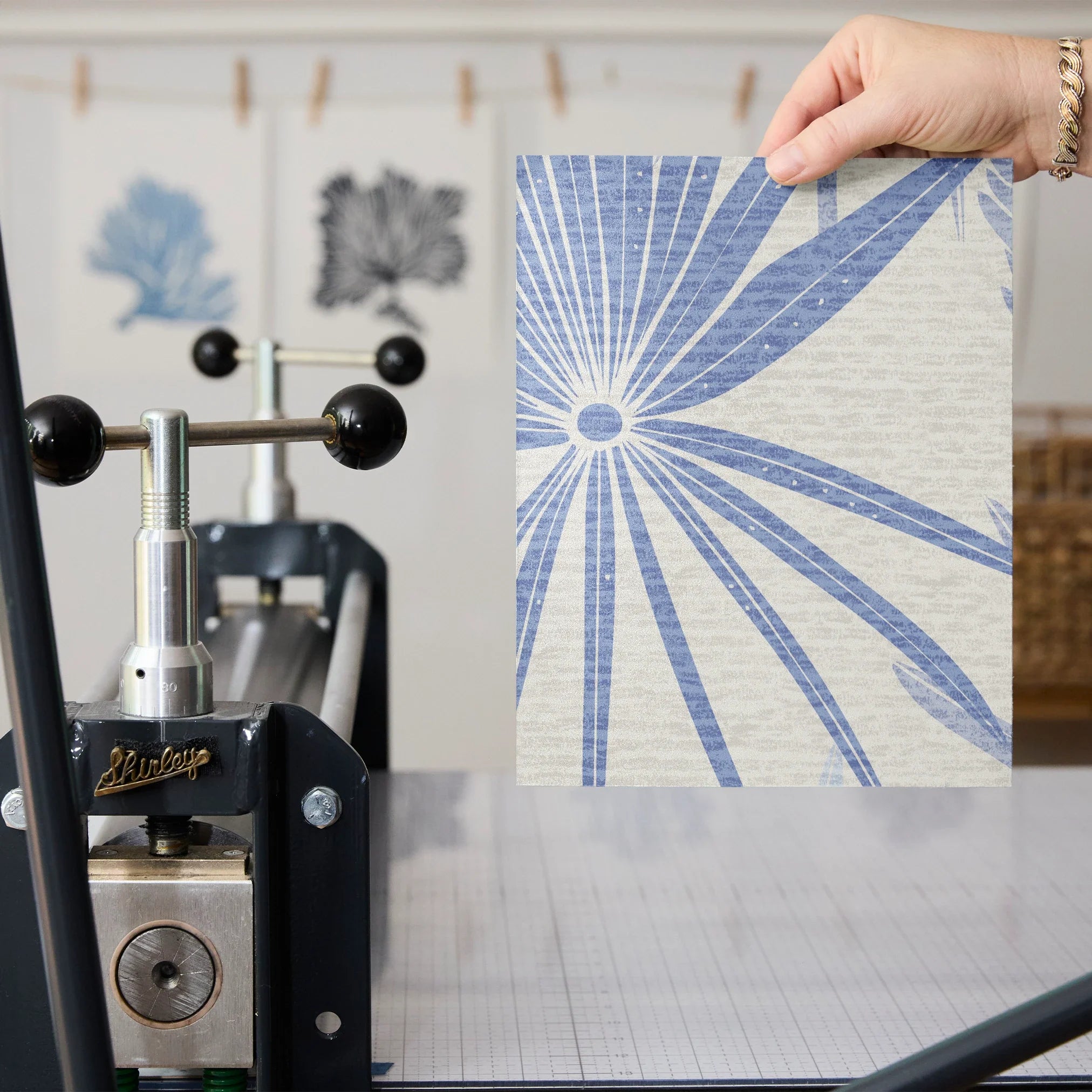 Blue and gray tropical palm fronds pattern on light textured background
