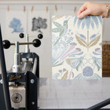 Symmetrical art nouveau pattern with stylized flowers, leaves, and butterflies in soft blue, purple,