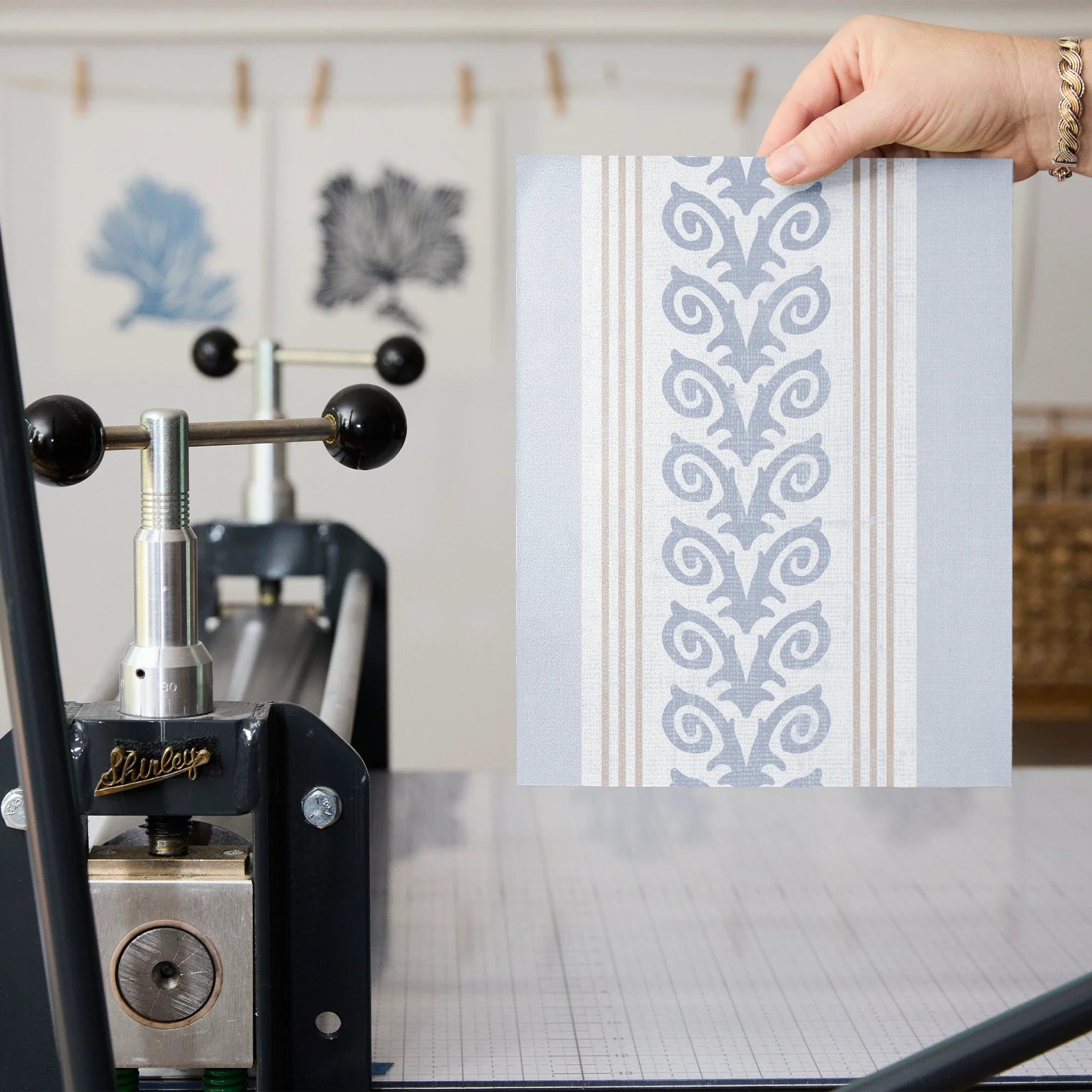 Blue and white vertical striped pattern with decorative floral motifs