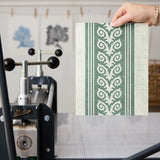 Vertical striped pattern with ornate scrollwork borders in sage green and cream tones