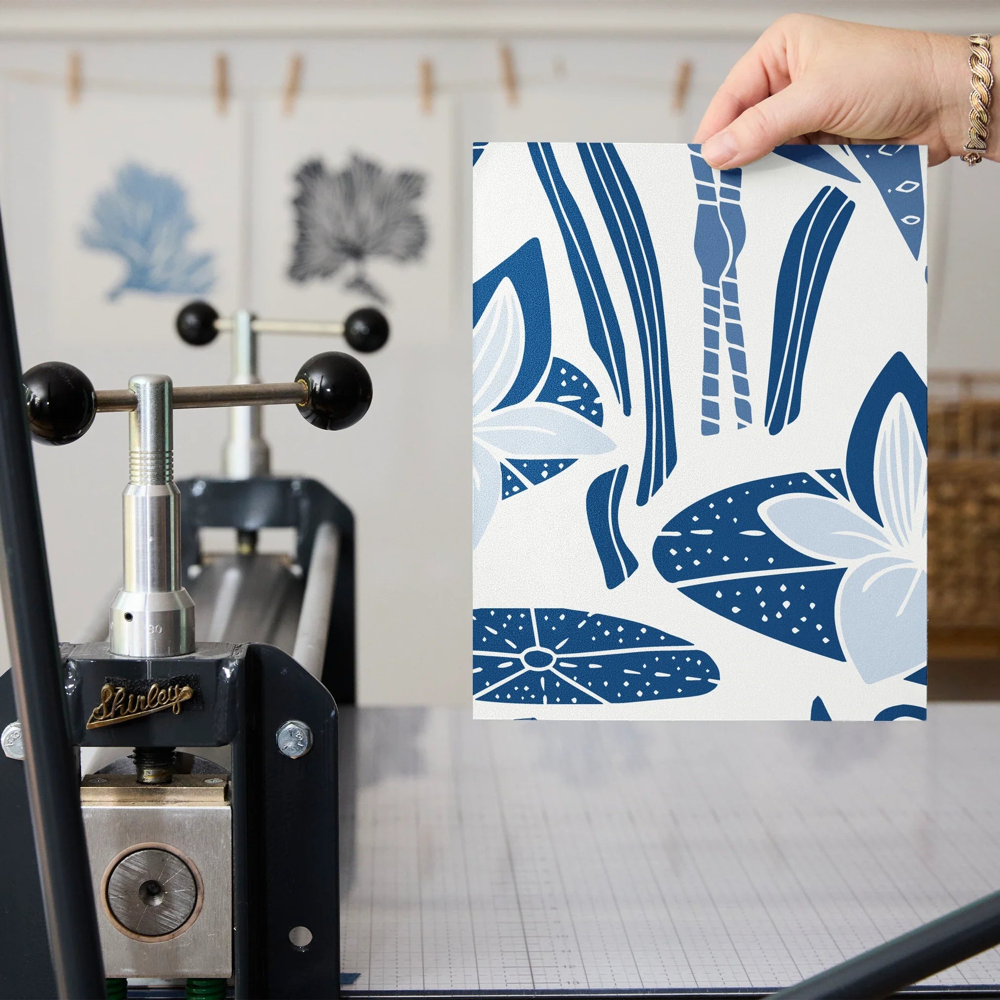 Blue and white decorative pattern with birds, flowers, and foliage in folk art style