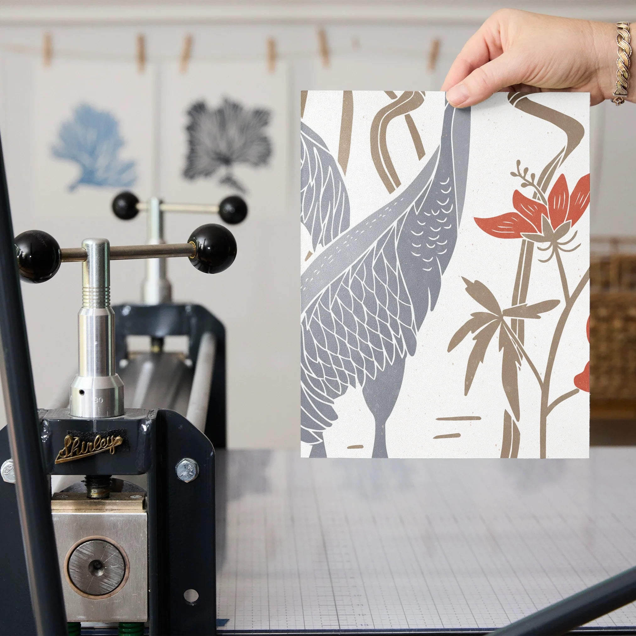 Decorative pattern with gray herons, beige rabbits, and coral-red flowers on white background