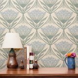 Art Nouveau floral pattern with stylized blue flowers and sage green leaves on cream background