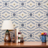 Geometric pattern with blue-gray curved shapes, circles, and beige accents on cream background