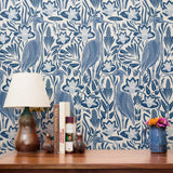 Blue and white decorative pattern with stylized birds, flowers, and botanical motifs in a folk art s