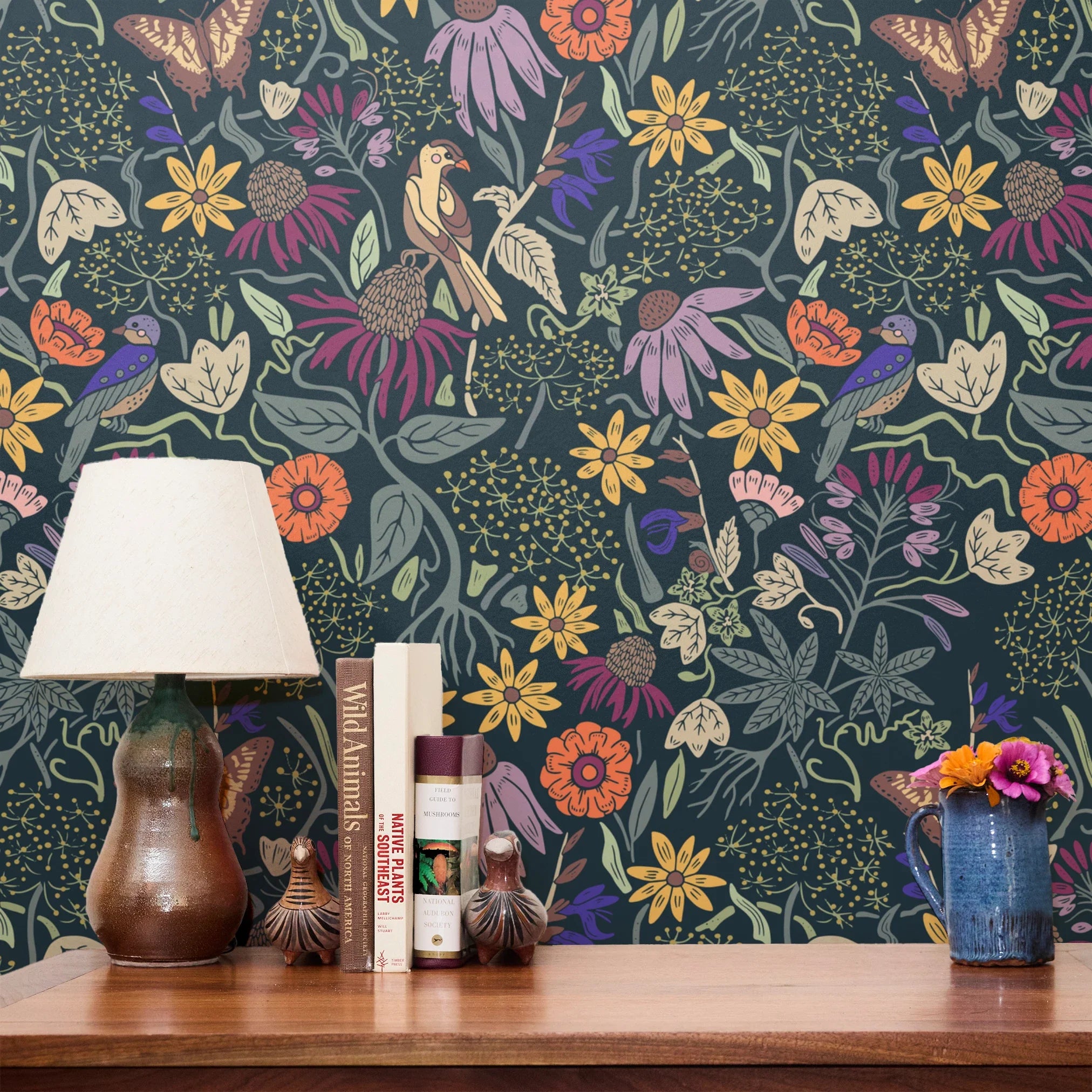 Vibrant floral pattern with colorful flowers, birds, and foliage on dark teal background