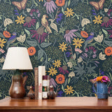 Vibrant floral pattern with colorful flowers, birds, and foliage on dark teal background