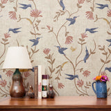Decorative pattern with blue birds, rust-colored flowers, and brown foliage on cream background