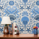 Symmetrical blue and white maritime pattern with starfish, crabs, shells, and fish motifs