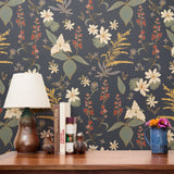 Vintage floral pattern with white flowers, golden stalks, and red blooms on dark gray background