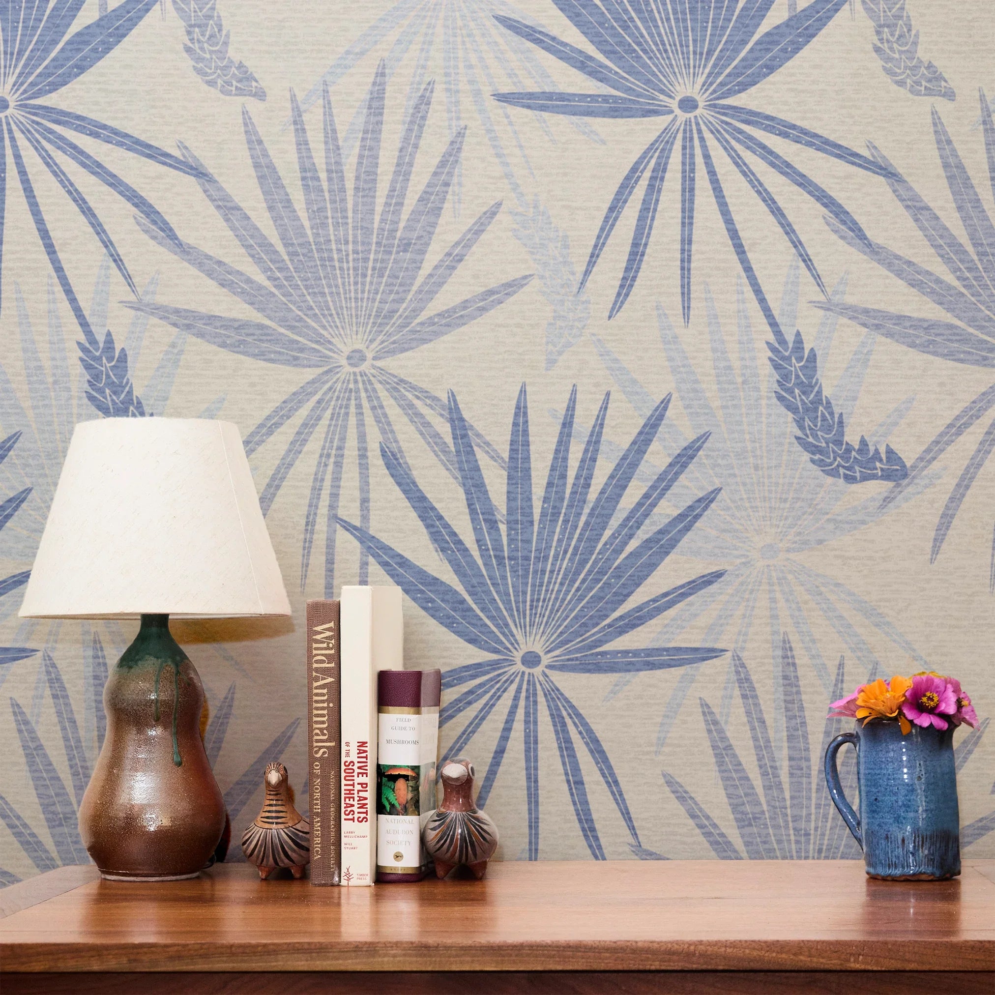 Blue and gray tropical palm fronds pattern on light textured background