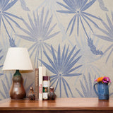 Blue and gray tropical palm fronds pattern on light textured background