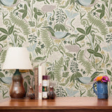 Decorative botanical pattern with green ferns, leaves, mushrooms, and flowers on cream background