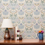 Symmetrical art nouveau pattern with stylized flowers, leaves, and butterflies in soft blue, purple,