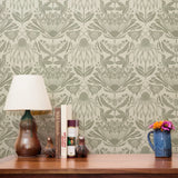 Symmetrical art nouveau botanical pattern with protea flowers, moths, and foliage in sage green on c