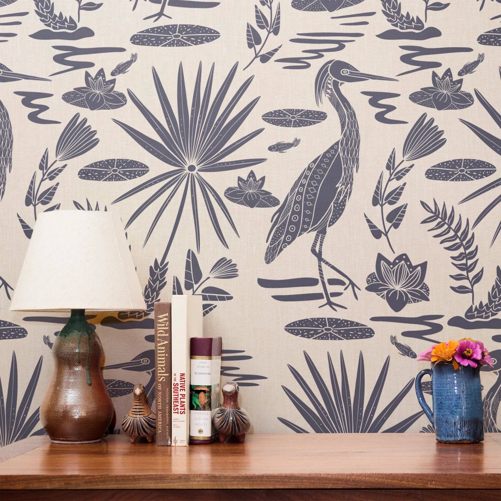 Tropical botanical pattern with blue herons, palm fronds, and foliage on cream background