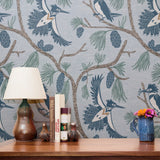 Birds perched on branches with pine cones and needles in blue, brown, and cream tones