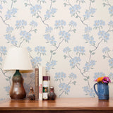 Delicate blue floral pattern with stems and leaves on white background