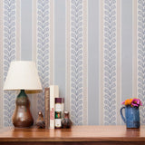 Blue and white vertical striped pattern with decorative floral motifs